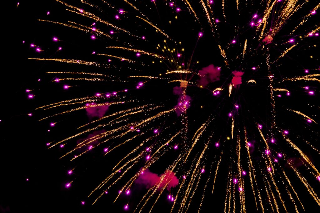 A dazzling night sky filled with vivid purple and gold fireworks in Tampa Florida